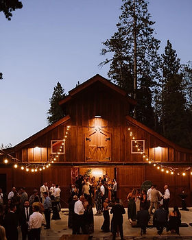 Wedding celebration in front of the barn at Miller’s Landing in Lake Arrowhead
