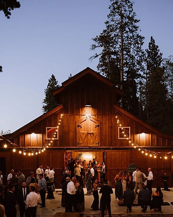 Wedding celebration in front of the barn at Miller’s Landing in Lake Arrowhead