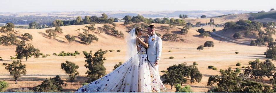 Couple at the infinity pool of Eagle Oak Ranch overlooking the golden hills of Paso Robles wine country