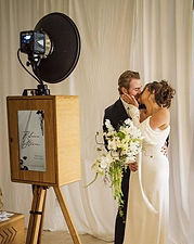Wedding couple posing in front of the Stay Golden Photo Booth setup in Southern California.