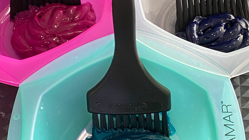 Close-up of vivid hair colors in bowls with brushes