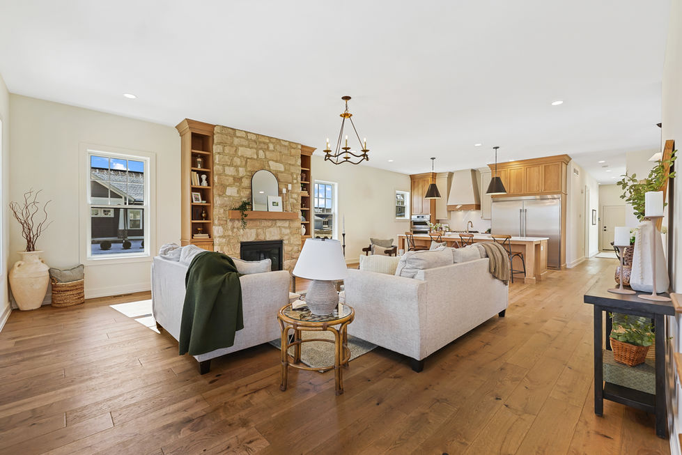 Living room with tall windows and modern furnishings.