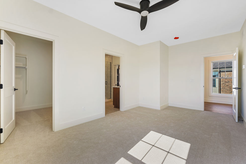 Bedroom with high ceiling and fan.