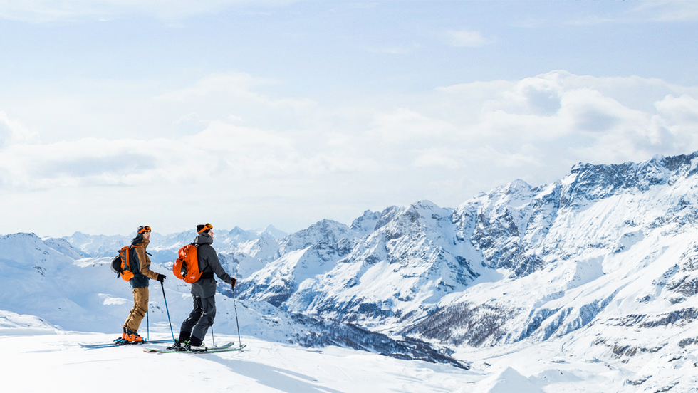 SAS Amex Classic Skiers on top of the alps