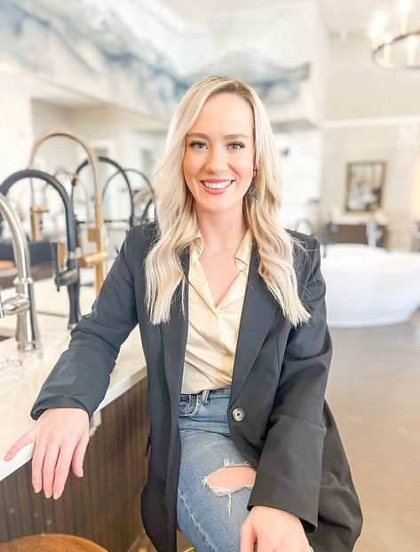 A woman sitting and smiling as a showroom coordinator
