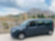 Dark-grey minivan parked near ancient Greek ruins