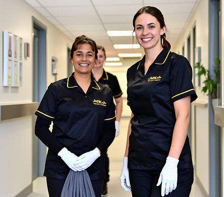 ladies cleaning medical centre wearing black MK Facility Group uniform (gold print).jpg