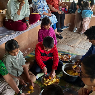 Families and travelers sharing fruit dishes at Mukteshwar Himalayan Fruit Festival organize by wilft adventuresdrift