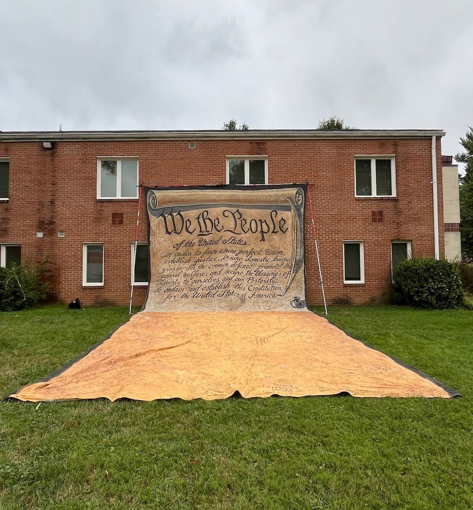 An original artwork of the preamble to the Constitution, created for the We Are America march by artist Lucy Larkin, displayed at Laurel Presbyterian Church on September 17. Marchers and supporters were invited to sign the canvas artwork. (Photo: Diane Mezzanotte)
