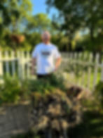 Tim Brennan takes a break from harvesting garlic in his garden.