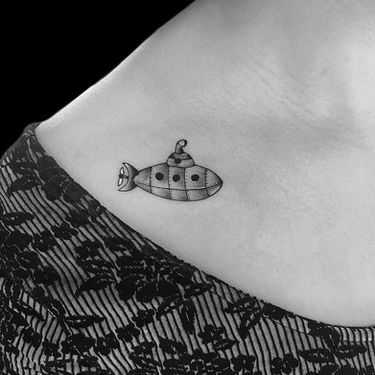 fine line submarine tattoo on collar bone 