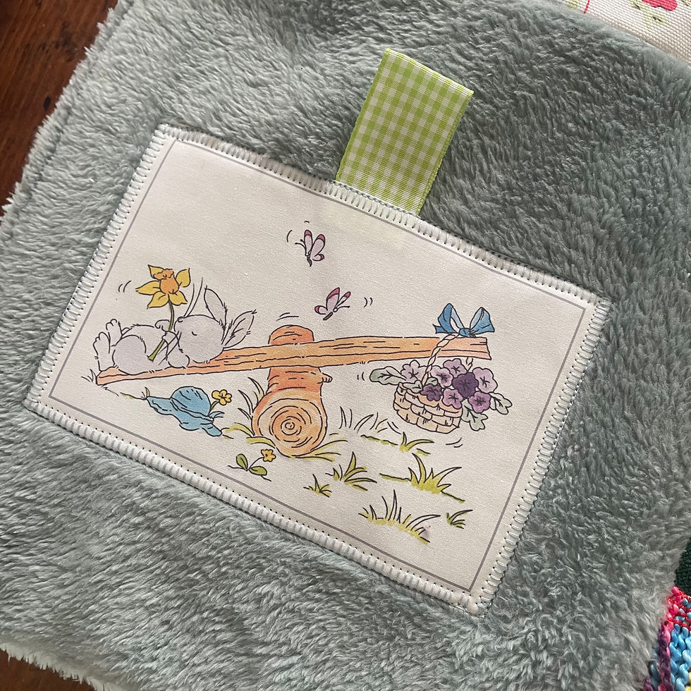 Thumbnail: Stitched patch on grey fleece with lime ribbon tag.