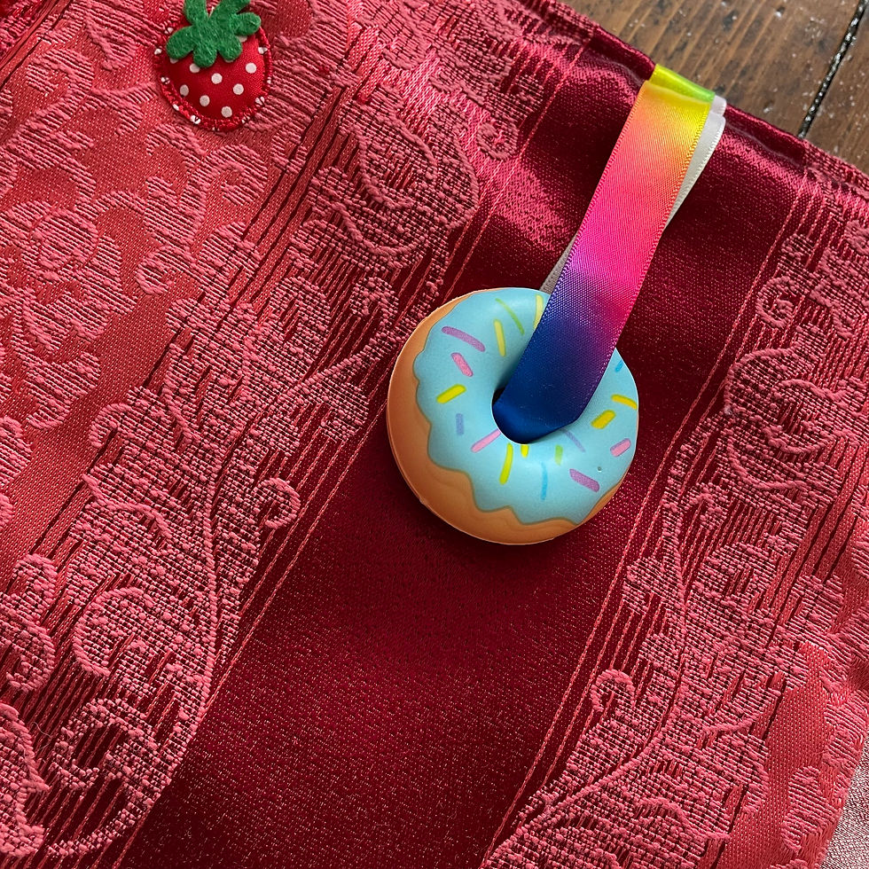Thumbnail: Sensory ring and strawberry tag detail on handmade fidget blanket, made in Ireland by The Owl Tree