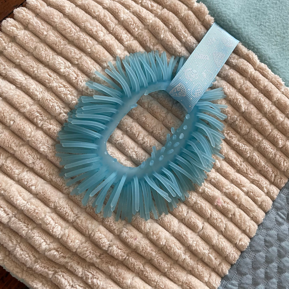 Thumbnail: Pale blue ruffled fidget ring on cream corduroy panel.