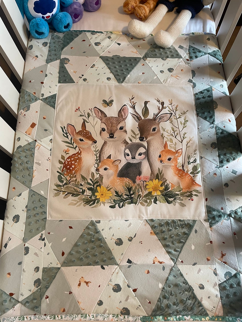 Handmade baby blanket with woodland deer panel and grey patchwork border, made in Ireland by The Owl Tree