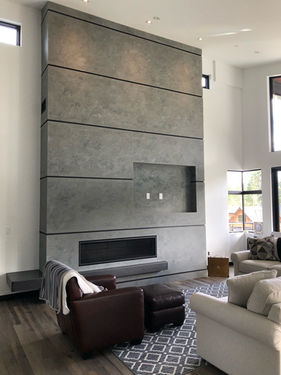 A grey Venetian Plaster fireplace.
