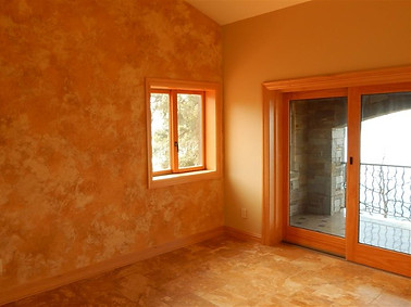 A sunset orange Venetian Plaster bedroom.