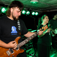 Local Band 'Rockit Fuel' performing live on stage at a live event.