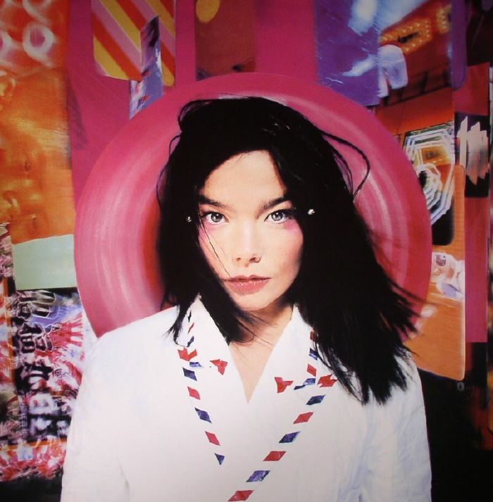 Bjork, Postalbum cover with a portrait of Björk wearing dark hair and bold pink makeup amongst a collection of abstract artworks.