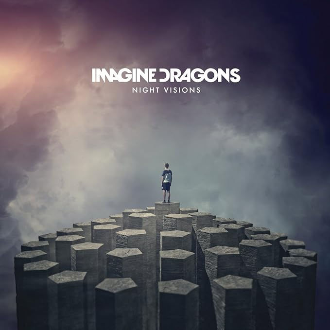 Imagine Dragons, Night Visions album cover, featuring a child stood on a structure resembling the giants causeway looking toward a grey smoky sky.