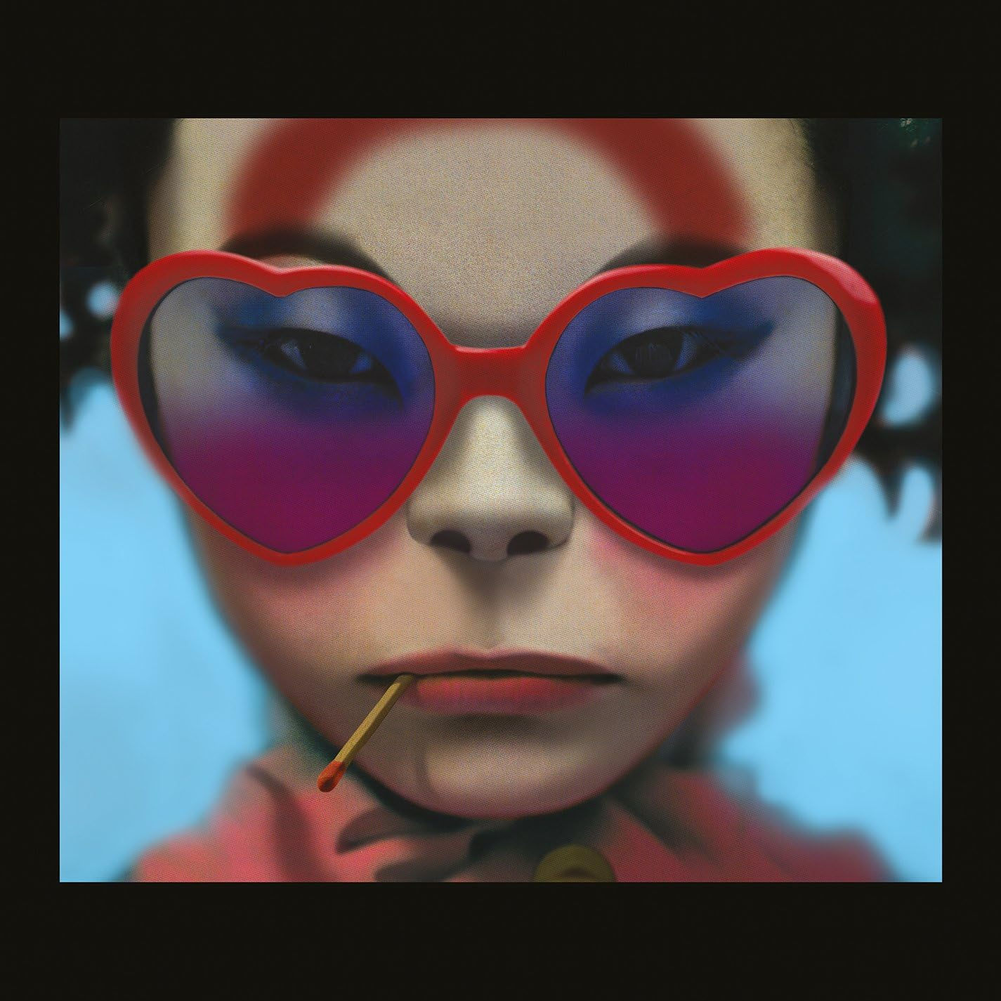The Gorillaz, Humanz album artwork depicting a Stylized cartoon face with red heart shaped sunglasses and matchstick hanging from her mouth. The image represents the virtual band member know as Noodle.