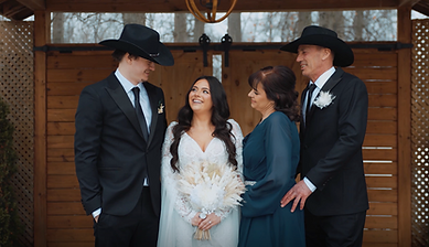Bride posing with family members during the wedding day.