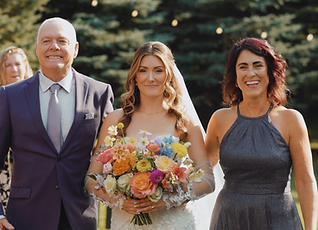 Bride walking down the aisle with her parents.
