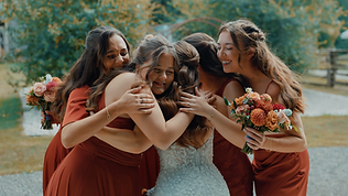 Bride hugging bridesmaids before the ceremony at a Niagara wedding.