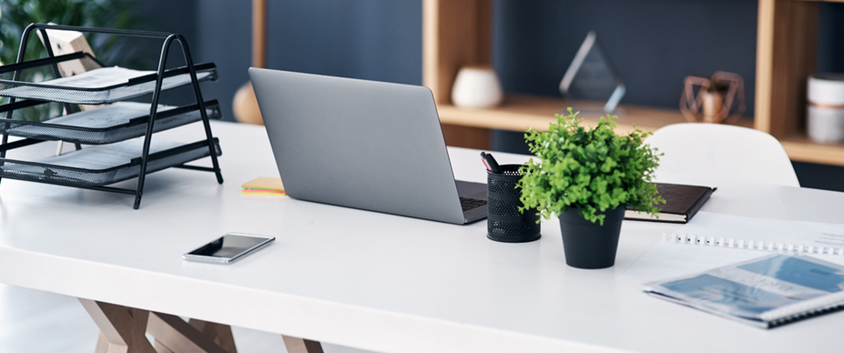 Home office station with laptop on table.