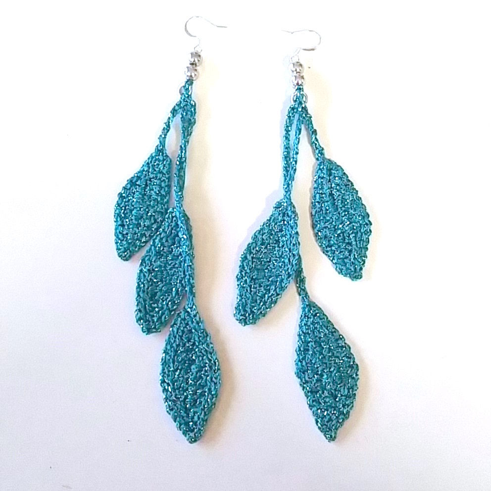 Exclusive crocheted hanging leaf motive earrings made of shimmering metallic yarn. 