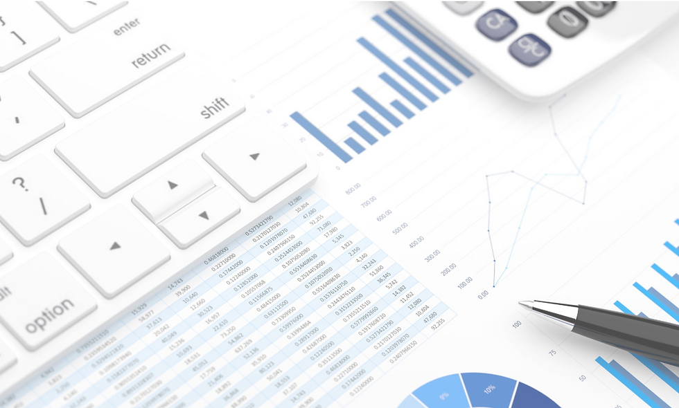 Picture of spreadsheet under a keyboard, calculator, and pen.