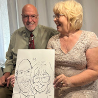 A couple  holds a caricture at a wedding at the slavonian lodge in Biloxi MS