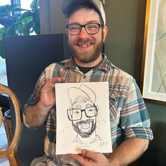 steve gets a caricature by kathy at the barn at hope farms in Fairhope, AL at mosquito joes tenth anniversary party