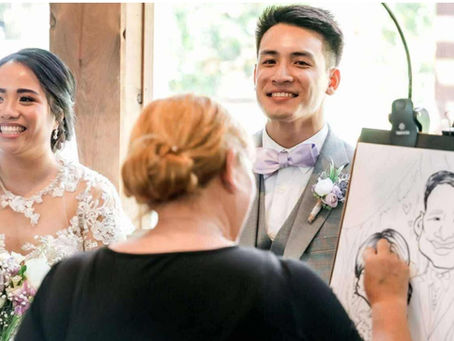 a bride and groom smile as their wedding caricature is being drawn