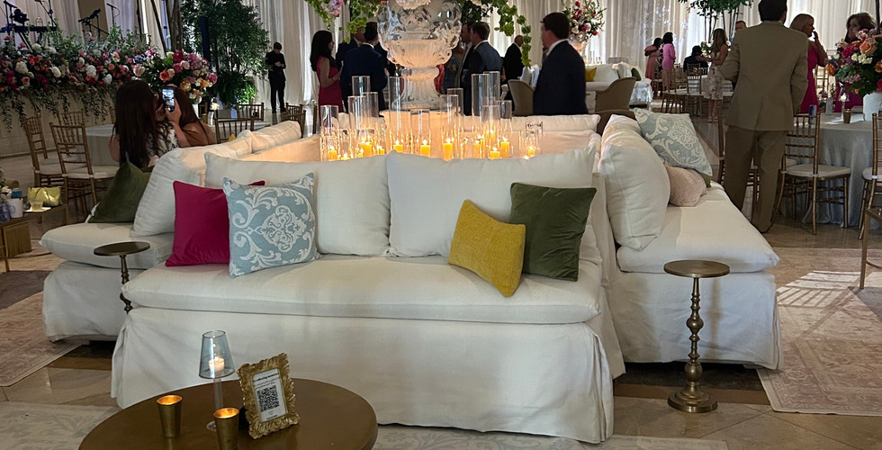 A fairy tale wedding with drapery, cushioned seating areas, & flowers everywhere 