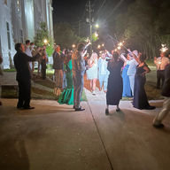 the bride and groom escape with sparklers all around
