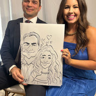A couple holds their caricature by caricature artist near me kathy buskett at a wedding at the slavonian lodge in Biloxi MS
