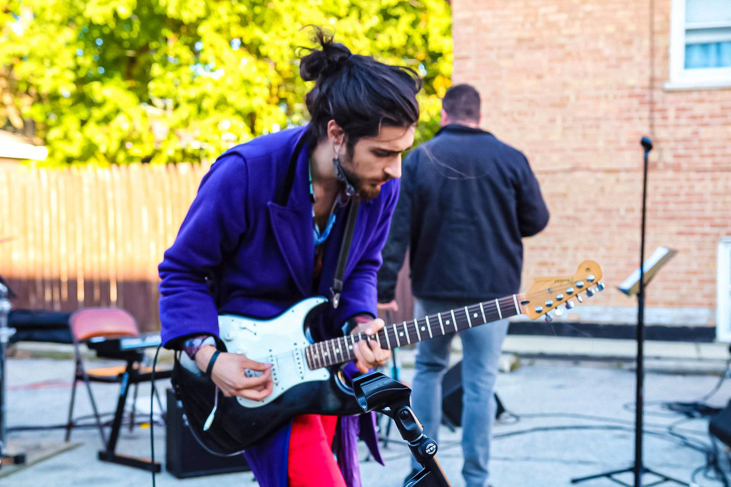 Man playing electric guitar outdoors