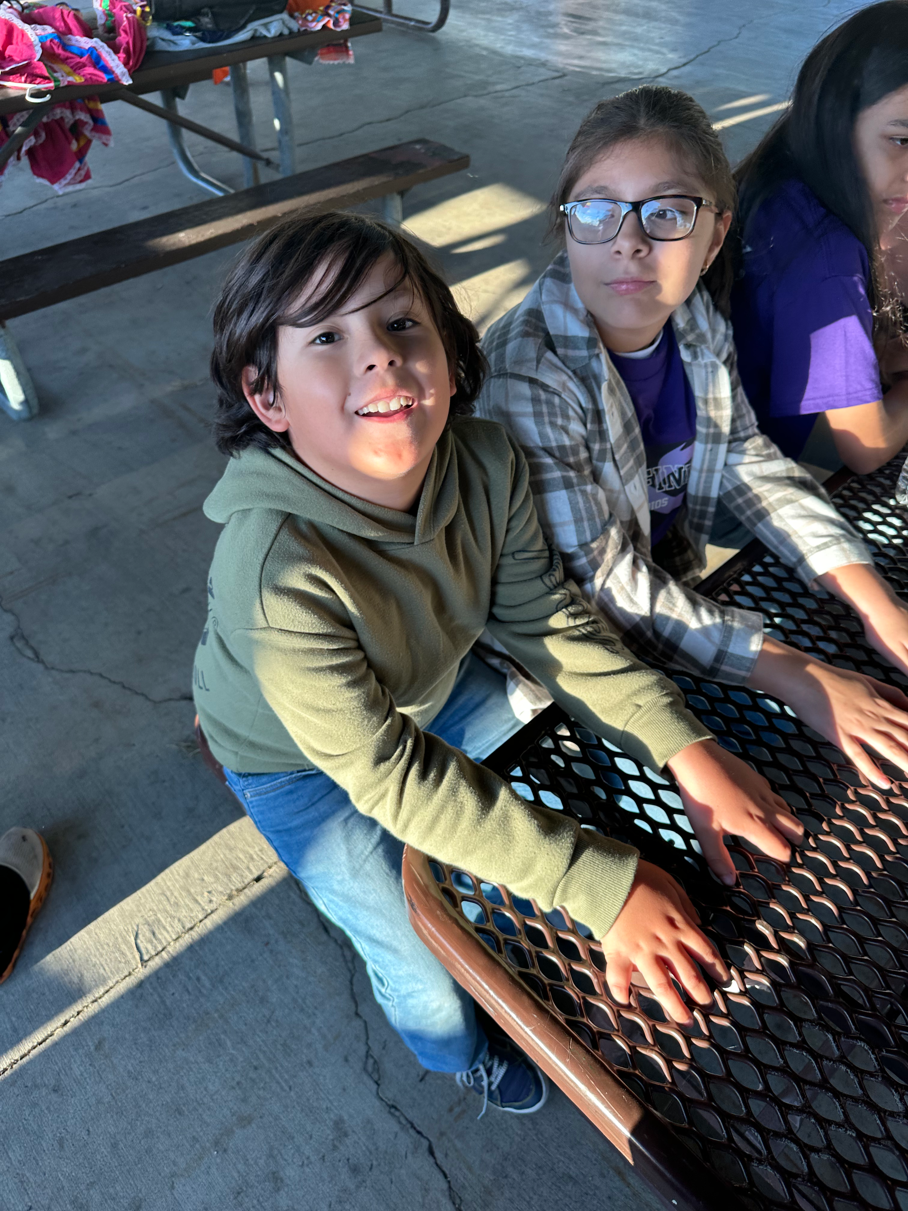 Smiling boy and girl at picnic table