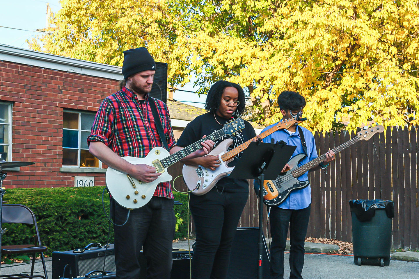 Band playing guitars outdoors autumn