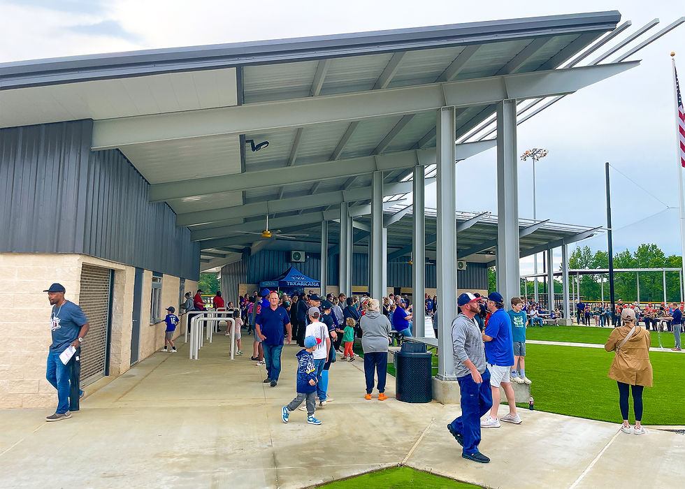 People walking through a covered concession area at a community park