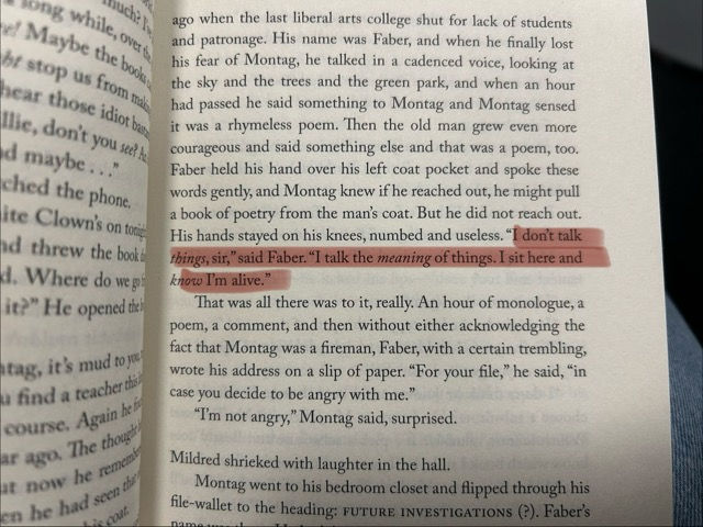 Close-up of a book page with a line highlighted in pink: "I don’t talk things, sir," said Faber. "I talk the meaning of things."