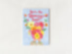 Hand-painted Mother’s Day card featuring hands holding vibrant flowers with the words “You’re the Blooming Best