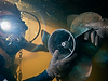 Diver cleaning boat propeller underwater