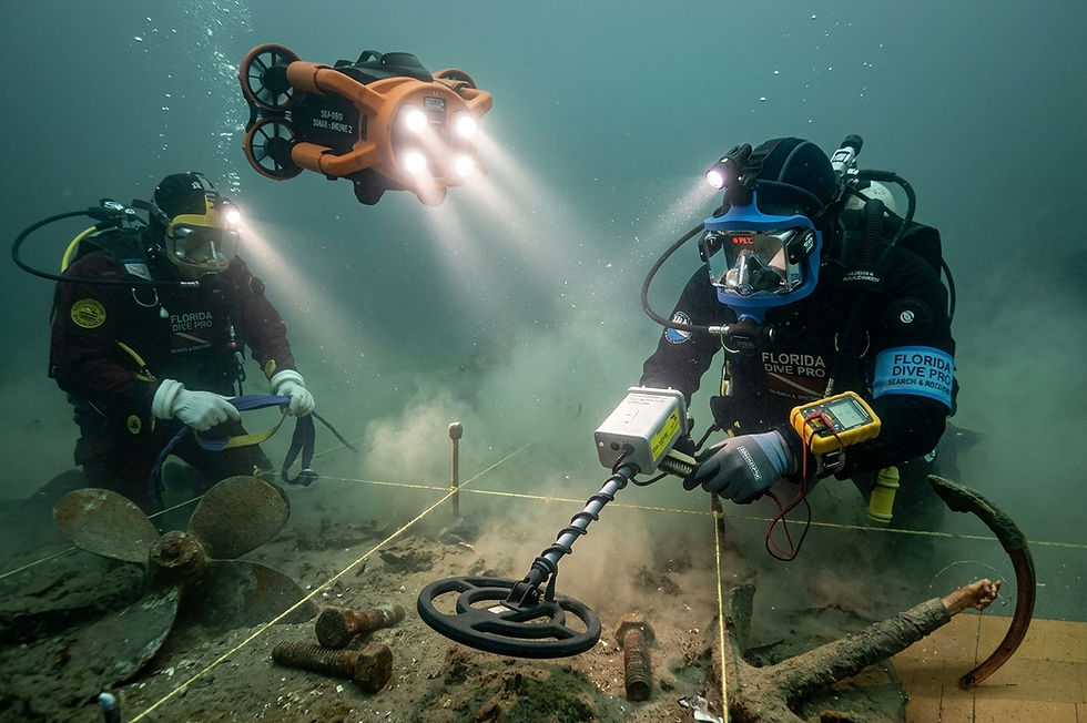 Two divers explore underwater with metal detector and drone