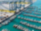 Busy port with numerous boats and cranes