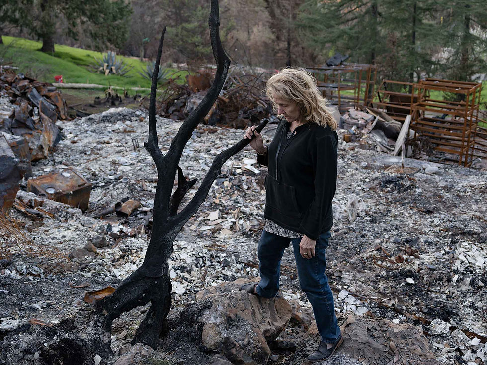 Kat Geneste looks through the debris of her Sonoma home. She hopes to rebuild so she can eventually sell the property.PHOTOGRAPHER: LUCAS FOGLIA FOR BLOOMBERG BUSINESSWEEK