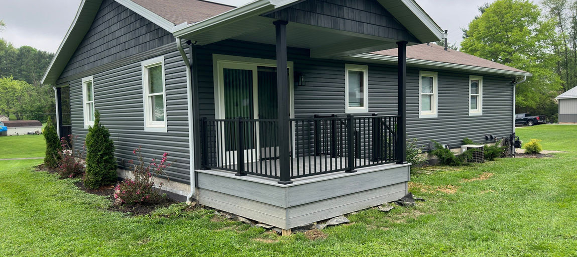 Dennison, Ohio home featuring Nightfall siding, composite decking, and black aluminum rails installed by a local contractor.