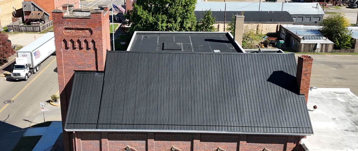 Newcomerstown, Ohio church featuring a Textured Black Premier Rib metal roof installed by local roofing contractor Pine Ridge Roofing LLC.