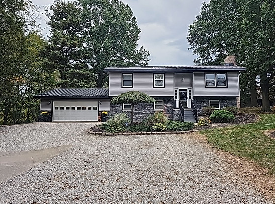 Strasburg, Ohio home featuring a Black Premier Rib metal roof installed by local roofing contractor Pine Ridge Roofing LLC.